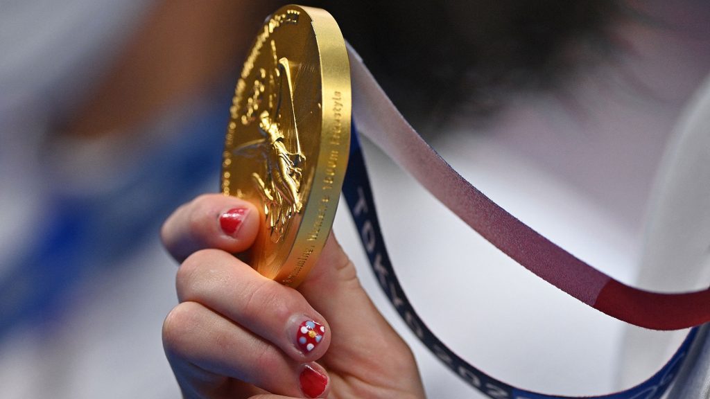 USA’s Kathleen Ledecky holds her gold medal after winning the 1500m freestyle swimming event