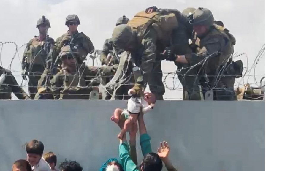 Afghan moms throw babies over barbed wire to British troops at airport