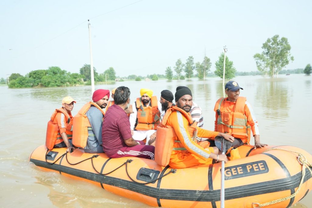 riding-boat,-punjab-cm-visits-flood-hit-areas